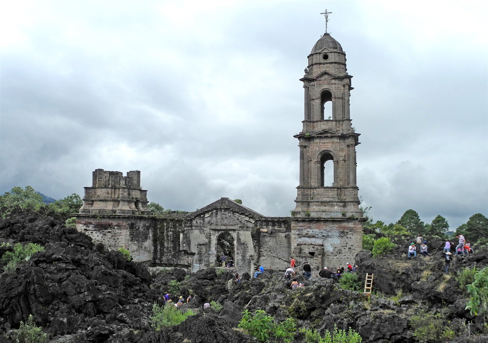 The church tower and façade rise above black lava at San Juan Parangaricutiro, Mexico