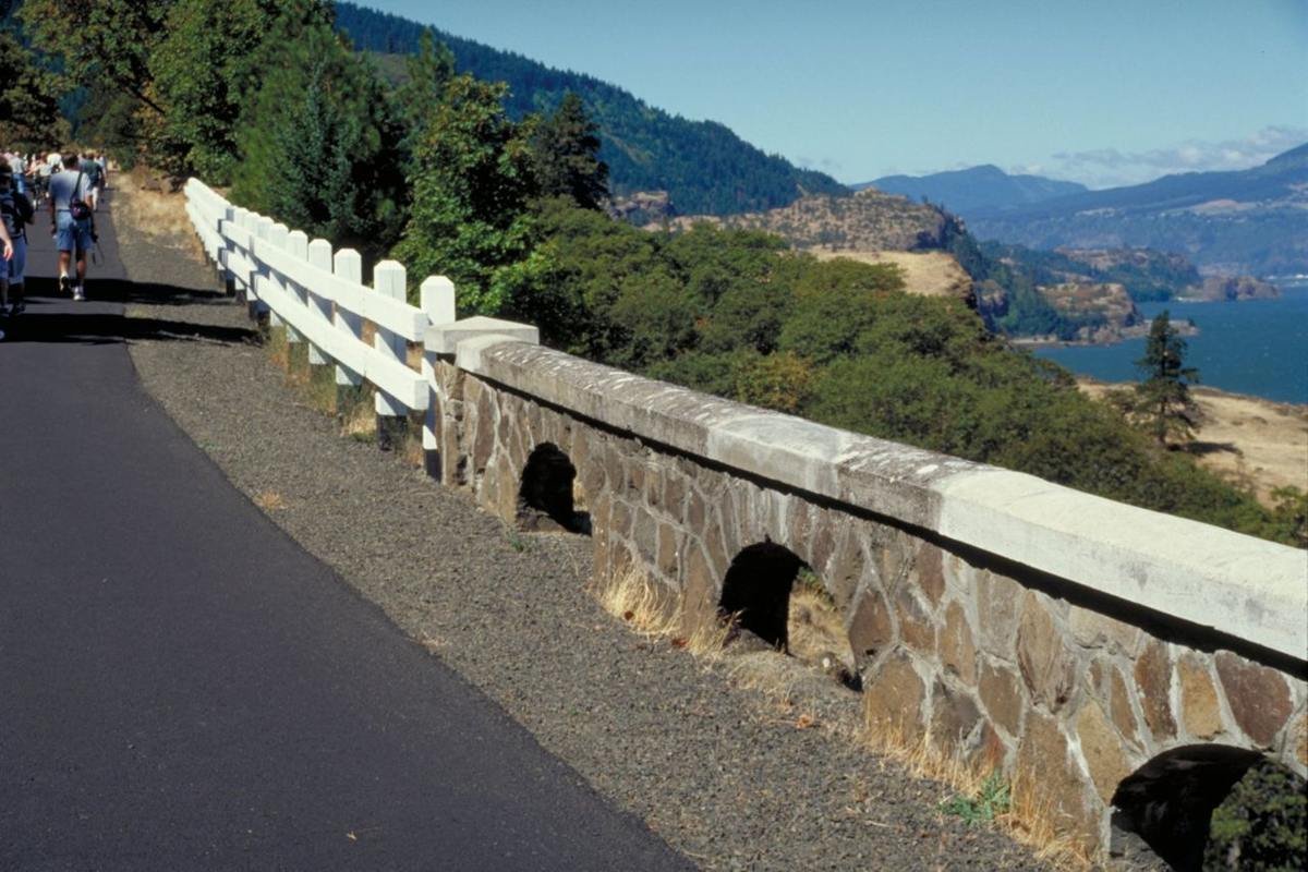The old wooden roadside railings conjoin the restored and original stone roadside railings on this section of the Historic Columbia River Highway
