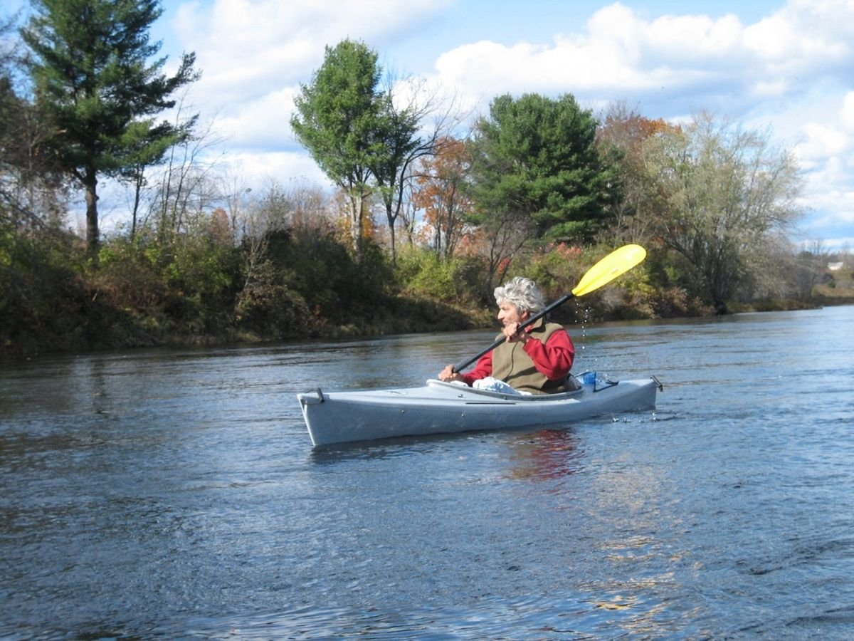A lone canoer enjoys the scenery while paddling the Kennebec River.