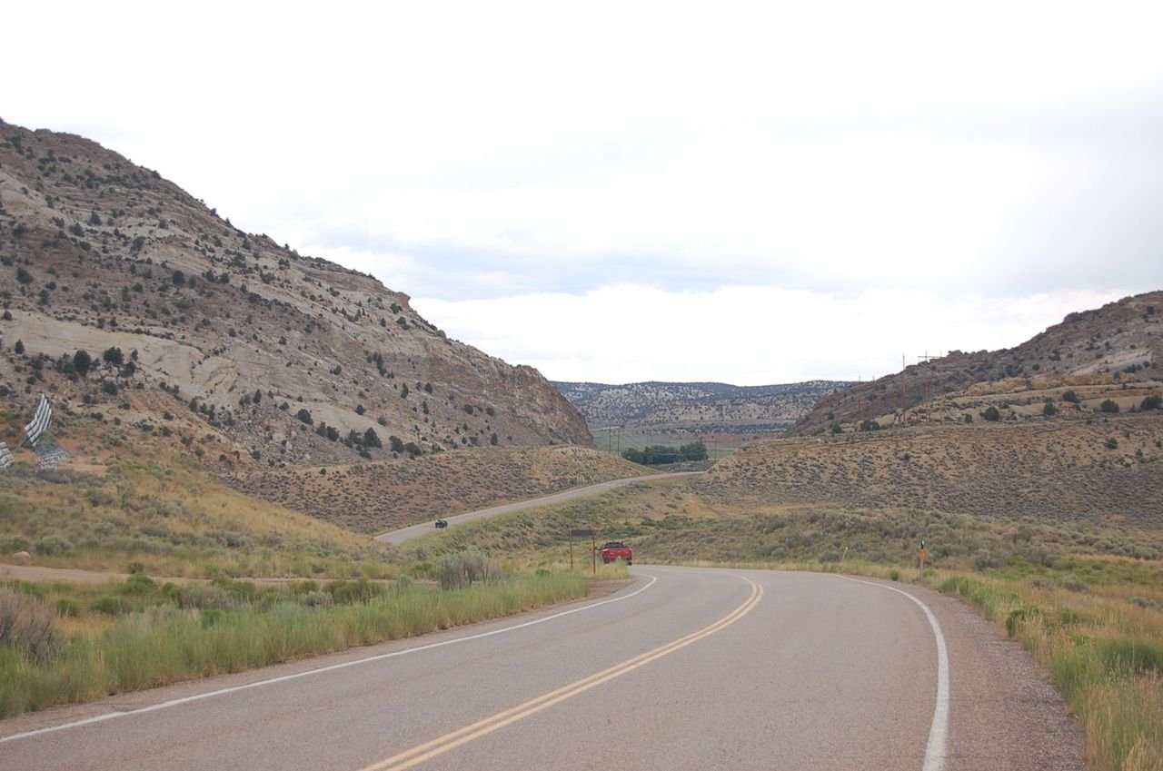 US Hwy 191 proceeds north through a gap in a slanted ridgeline on the east side of Flaming Gorge Reservoir.