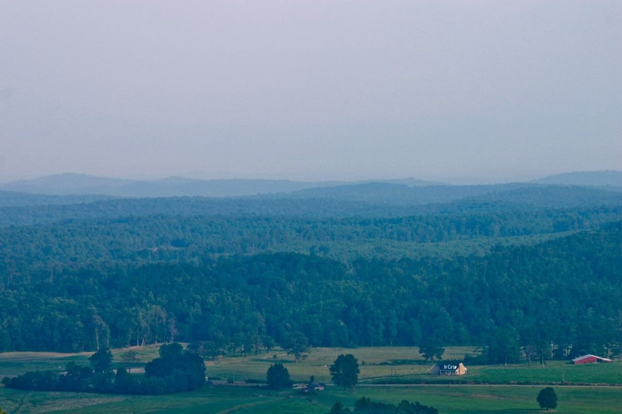 Clouds fall gently on the green hills surrounding the Talladega Scenic Drive.