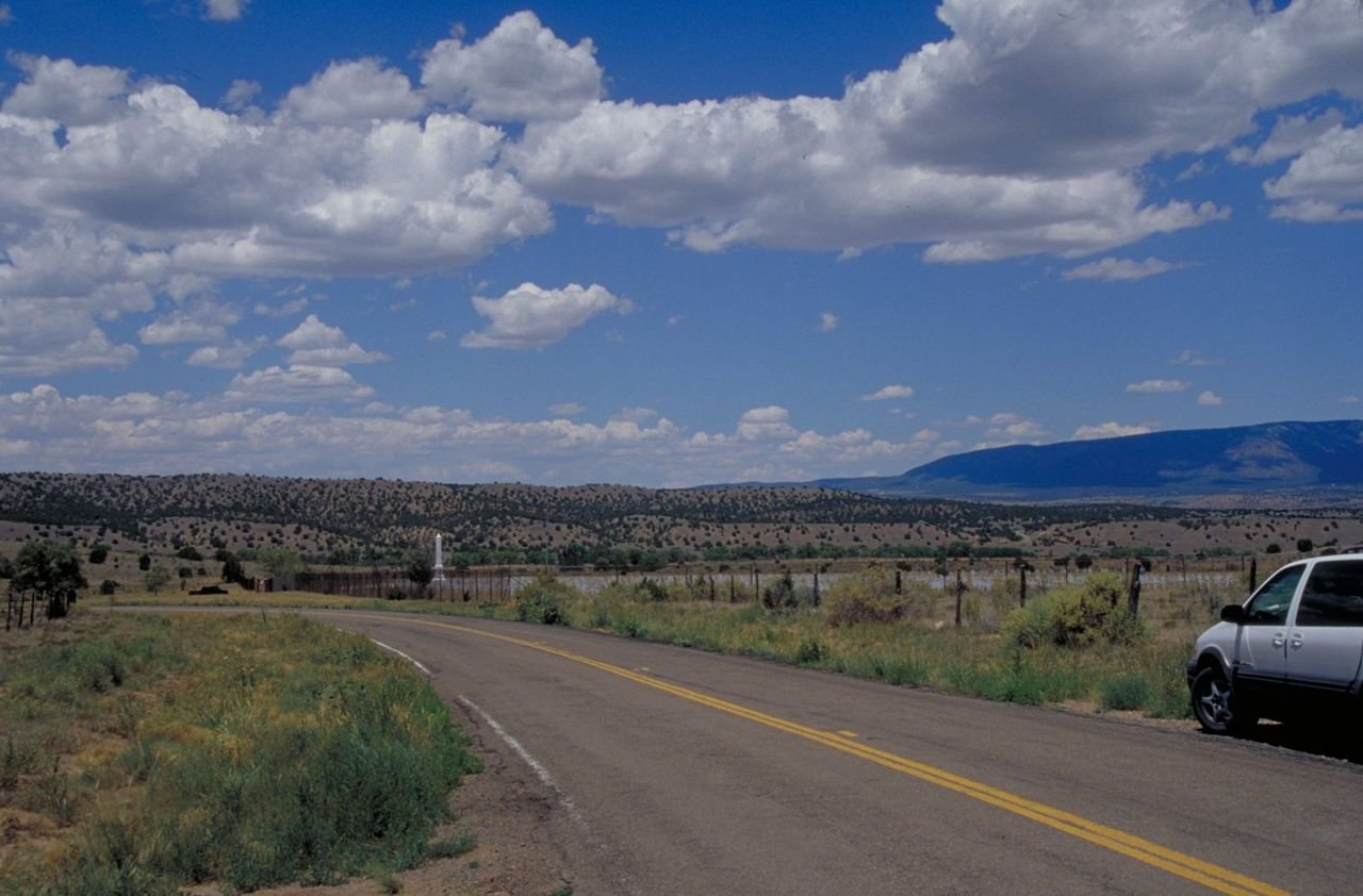 Rows of crosses and a taller monument are seen in this view of Fort Stanton Military Cemetery on the Billy the Kid Scenic Byway.