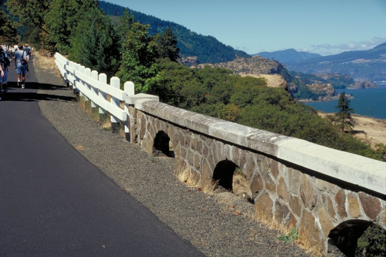 The old wooden roadside railings conjoin the restored and original stone roadside railings on this section of the Historic Columbia River Highway
