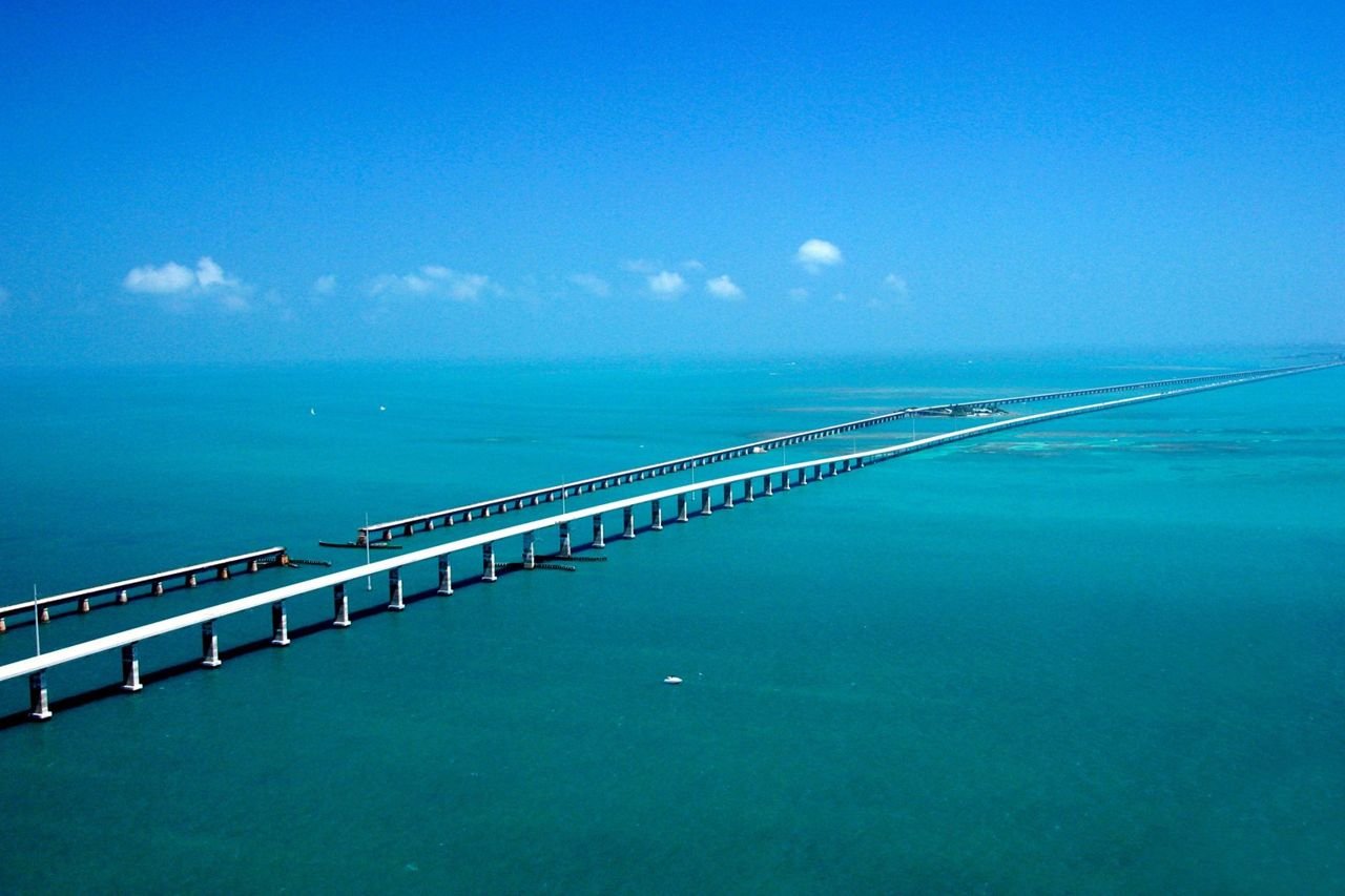Seeming to converge in the distance, the Seven-mile Bridge on the Florida Keys Scenic Highway west of Marathon, FL, runs parallel to the historic Flagler railroad bridge of the early 1900s with the Atlantic Ocean to the South and the Gulf of Mexico to the North.